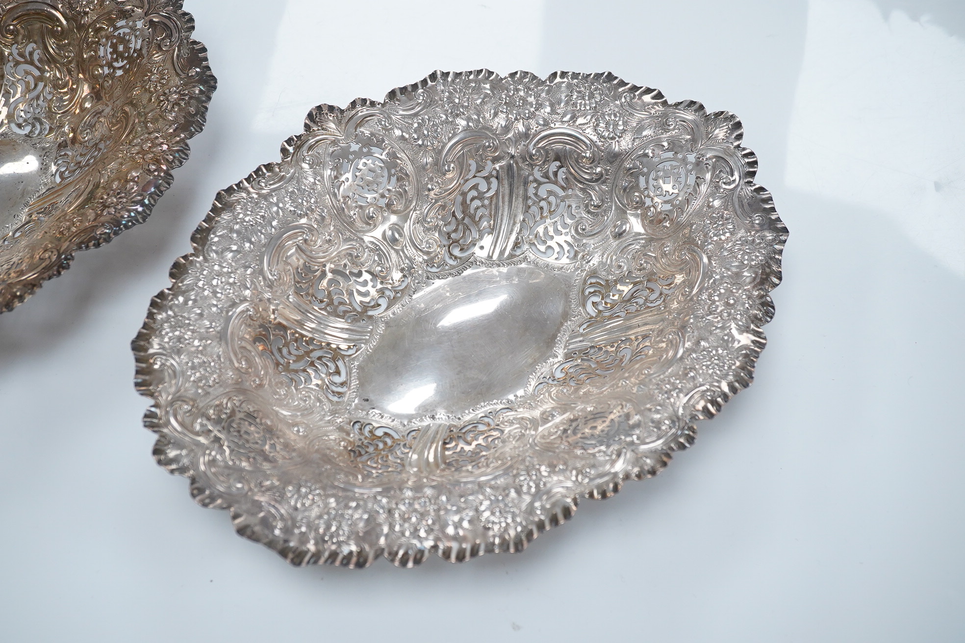 A pair of late Victorian pierced silver oval dishes, by Atkin Brothers, Sheffield, 1896, 27.9cm, 19.7oz. Condition - fair to good